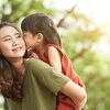 Daughter kissing mother