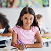 Student girl writing on the school lesson