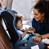 Baby girl sitting in a child seat and mother laughing