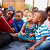 Teacher showing a book for children