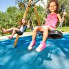 Two little girl playing on the swing