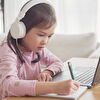 Girl With Headphones Taking Notes