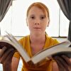 Redhead Teenager Girl Showing Book Opened